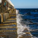 The waves crash along the lower ledges of the Ogden Point Breakwater in Victoria, BC.